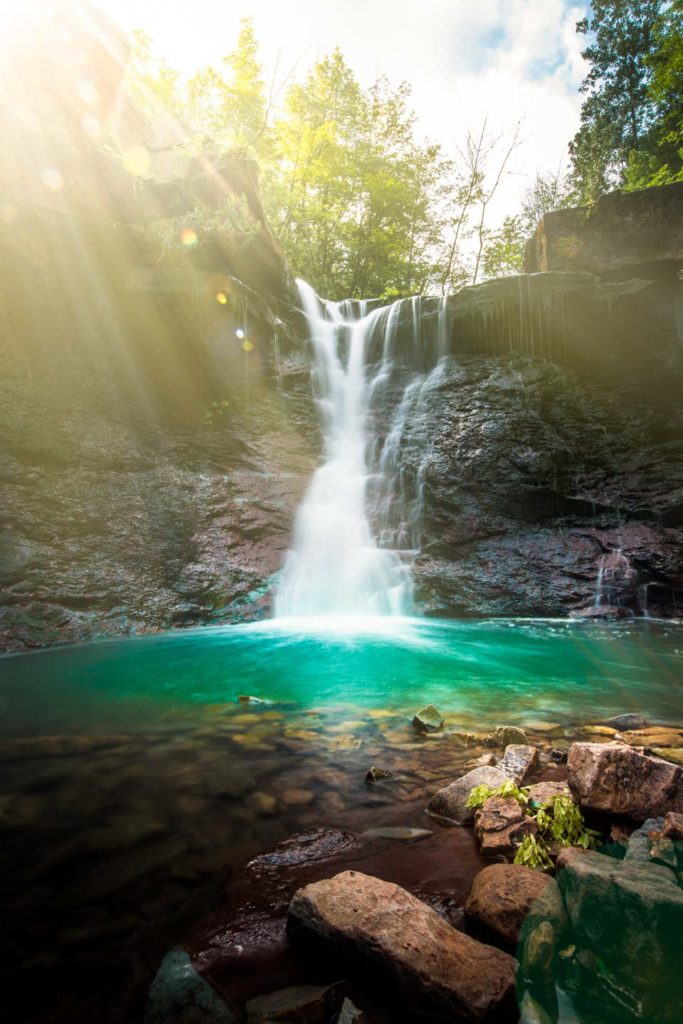 image of lower chedoke falls in hamilton ontario with sunbeams coming through