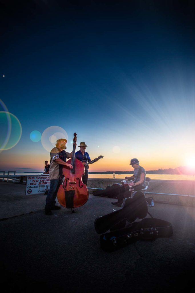 image of folk band singing in front of a beautiful sunset in port dover ontario